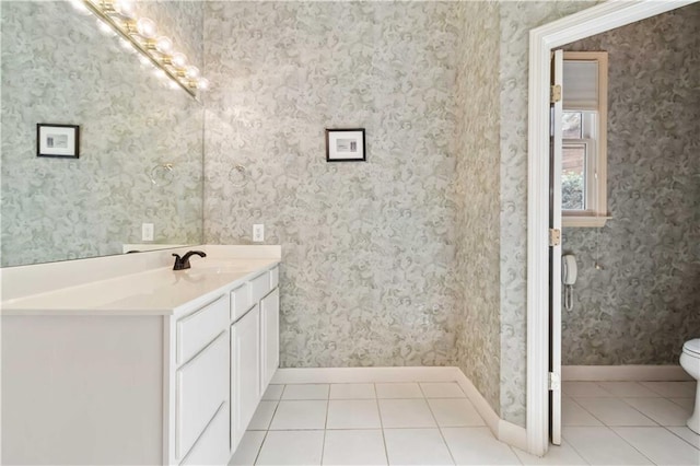 bathroom with wallpapered walls, tile patterned floors, and toilet