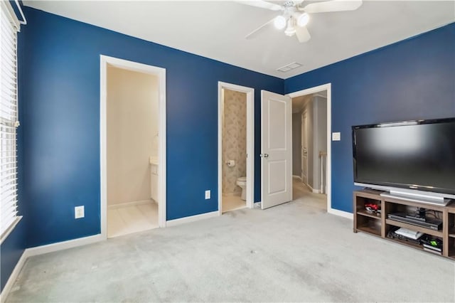 unfurnished bedroom with carpet flooring, connected bathroom, visible vents, and baseboards