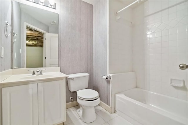 full bath with tile patterned floors, toilet, baseboards, bathtub / shower combination, and vanity