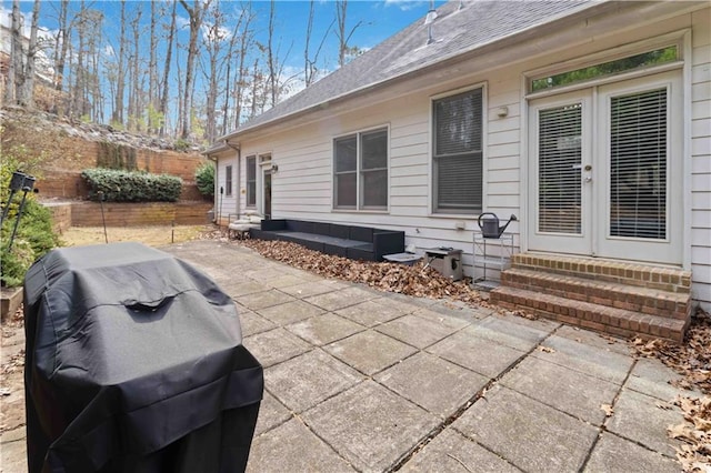 view of patio featuring french doors, a grill, and entry steps