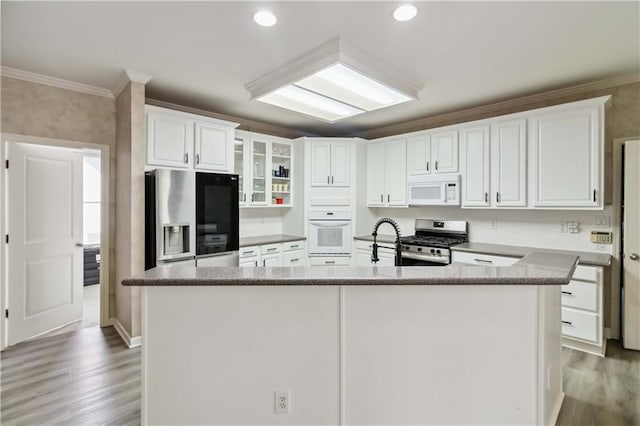 kitchen with white cabinetry, stainless steel appliances, and crown molding