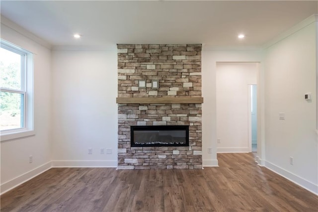 129 Henley St, Canton, GA 30114 - unfurnished living room featuring wood finished floors, crown molding, a stone fireplace, and recessed lighting