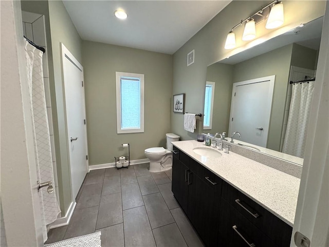 bathroom with visible vents, baseboards, toilet, vanity, and tile patterned floors