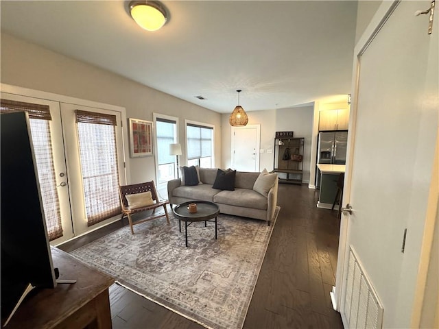 living area with dark wood-type flooring and visible vents