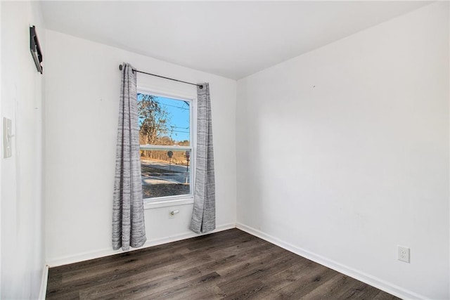 spare room with dark hardwood / wood-style flooring