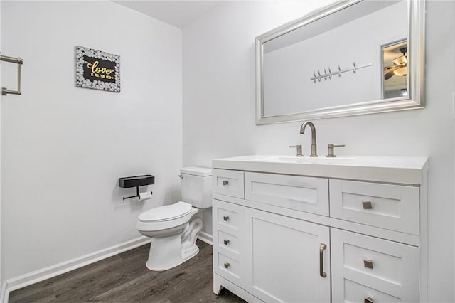 bathroom featuring vanity, hardwood / wood-style floors, and toilet