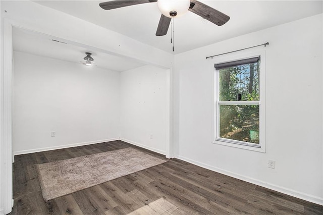 empty room featuring dark hardwood / wood-style floors and ceiling fan