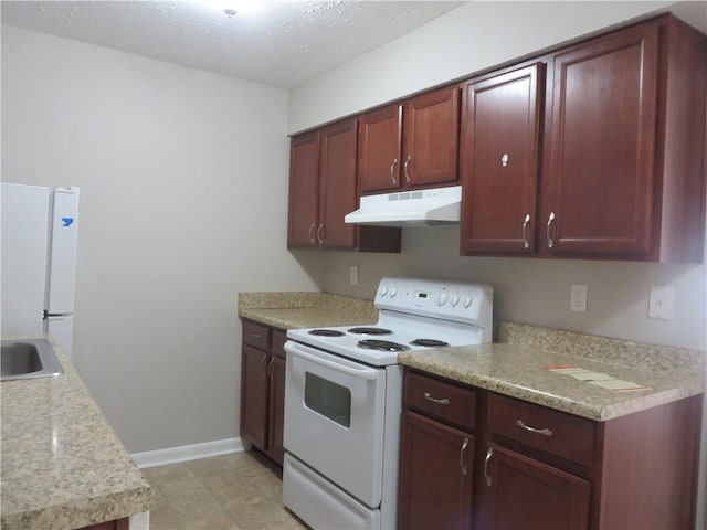 kitchen featuring a textured ceiling, white appliances, and sink