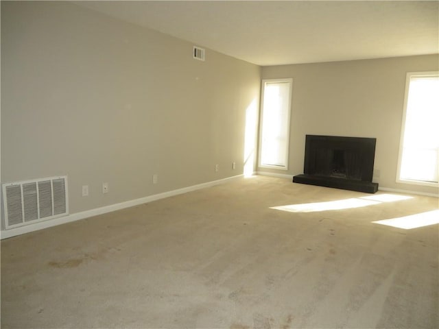 unfurnished living room with light colored carpet