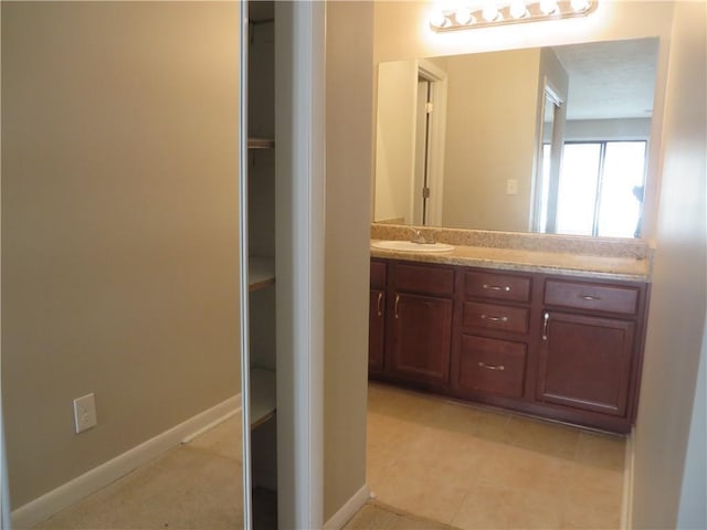 bathroom with tile patterned flooring and vanity