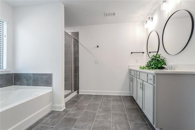 bathroom featuring tile patterned flooring, vanity, and independent shower and bath