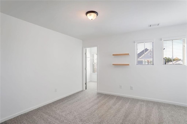 unfurnished room featuring carpet