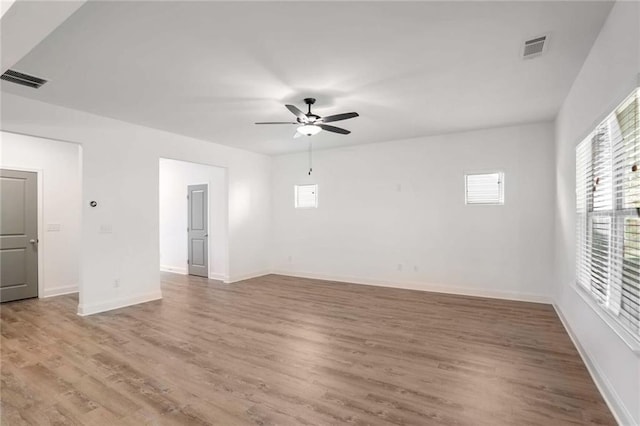 unfurnished room with ceiling fan and wood-type flooring