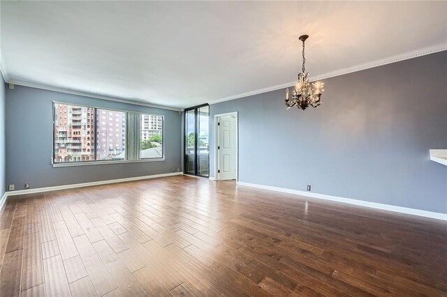 3481 Lakeside Dr NE Unit 1107, Atlanta, GA 30326 - empty room featuring a chandelier, ornamental molding, dark wood-style floors, and baseboards