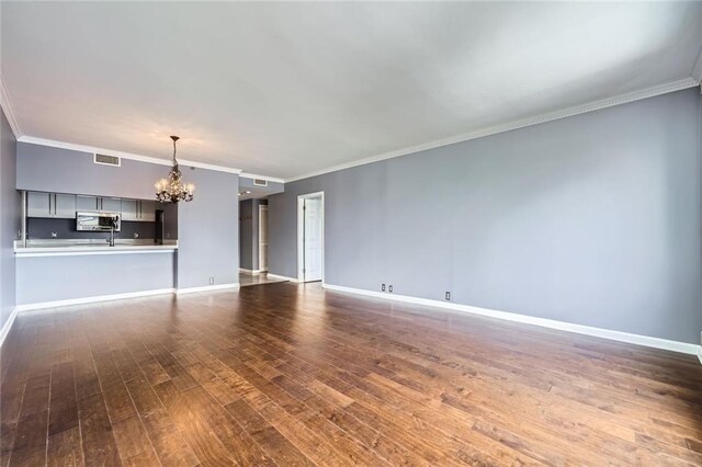 3481 Lakeside Dr NE Unit 1107, Atlanta, GA 30326 - unfurnished living room featuring a chandelier, dark wood-style floors, baseboards, and ornamental molding
