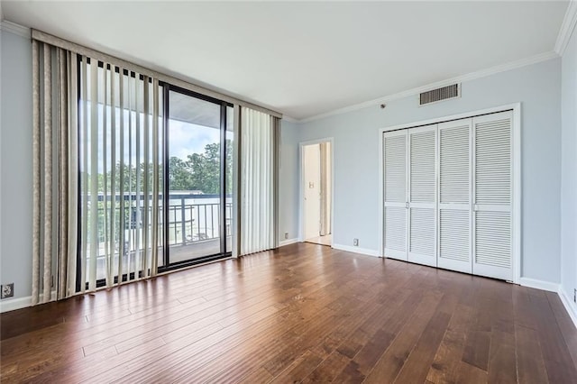 3481 Lakeside Dr NE Unit 1107, Atlanta, GA 30326 - unfurnished bedroom featuring access to exterior, ornamental molding, dark wood-style floors, expansive windows, and baseboards