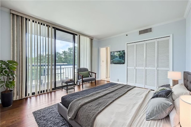 3481 Lakeside Dr NE Unit 1107, Atlanta, GA 30326 - bedroom with access to outside, expansive windows, crown molding, wood finished floors, and a closet