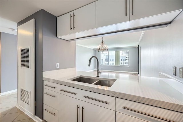 3481 Lakeside Dr NE Unit 1107, Atlanta, GA 30326 - kitchen with a sink, a heating unit, light stone counters, a chandelier, and white cabinets