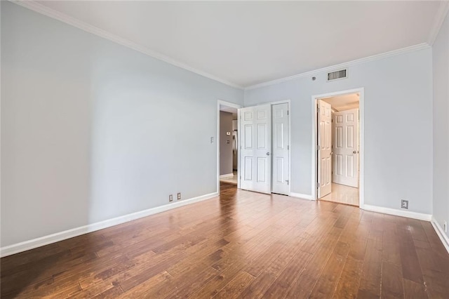 3481 Lakeside Dr NE Unit 1107, Atlanta, GA 30326 - unfurnished bedroom featuring wood-type flooring, baseboards, crown molding, and a closet