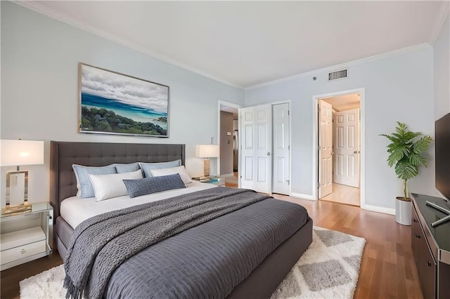 3481 Lakeside Dr NE Unit 1107, Atlanta, GA 30326 - bedroom featuring wood finished floors, crown molding, baseboards, and a closet