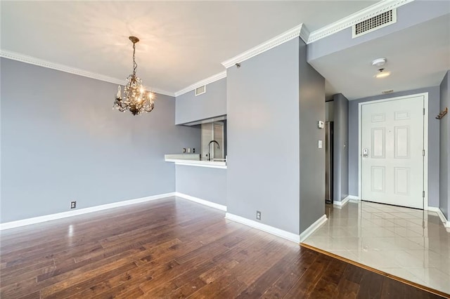3481 Lakeside Dr NE Unit 1107, Atlanta, GA 30326 - spare room with wood-type flooring, a chandelier, baseboards, and crown molding