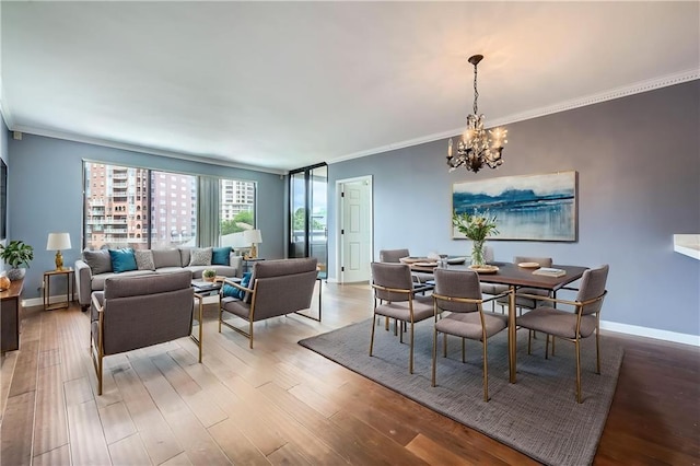 3481 Lakeside Dr NE Unit 1107, Atlanta, GA 30326 - dining space featuring crown molding, a chandelier, baseboards, and wood finished floors
