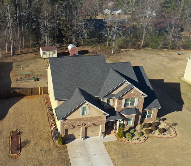 view of front of property featuring driveway and brick siding