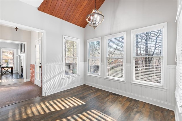 unfurnished sunroom featuring lofted ceiling, an inviting chandelier, and wood ceiling