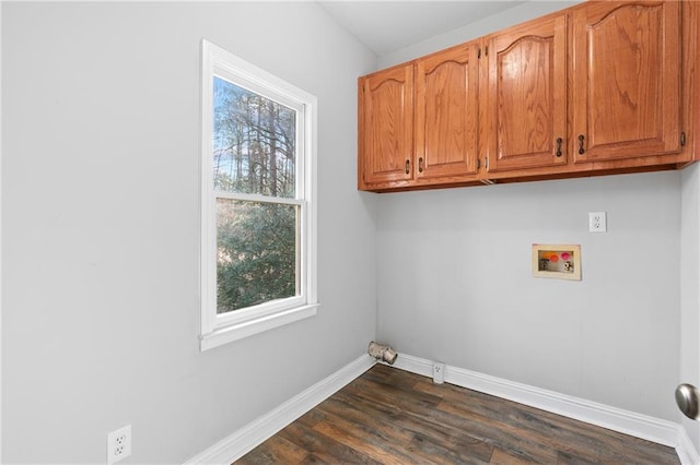 laundry area with washer hookup, dark wood-type flooring, and cabinets