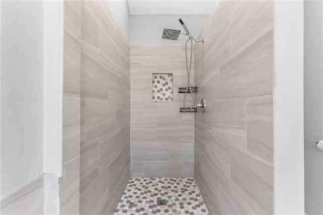 bathroom with tiled shower