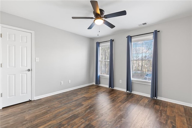 spare room featuring ceiling fan and dark hardwood / wood-style flooring