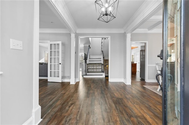 entryway featuring ornamental molding, dark hardwood / wood-style floors, and ornate columns