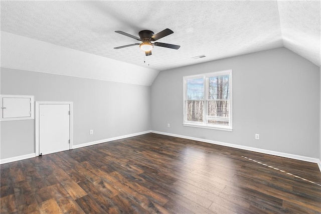 bonus room featuring vaulted ceiling, ceiling fan, a textured ceiling, and dark hardwood / wood-style flooring