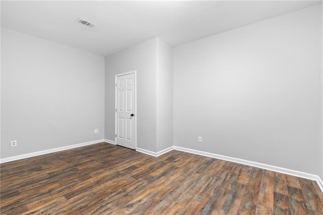 spare room with dark hardwood / wood-style floors