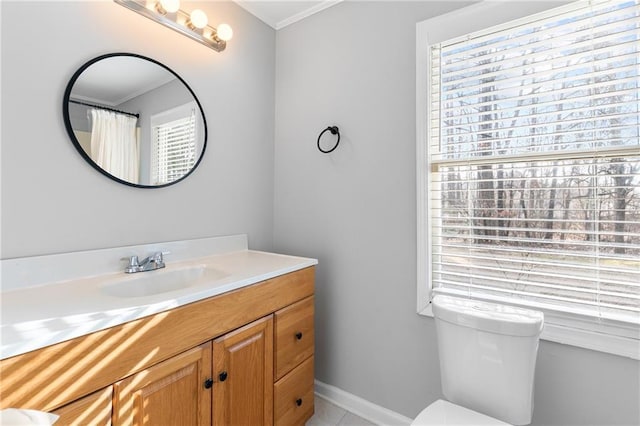 bathroom featuring crown molding, vanity, and toilet