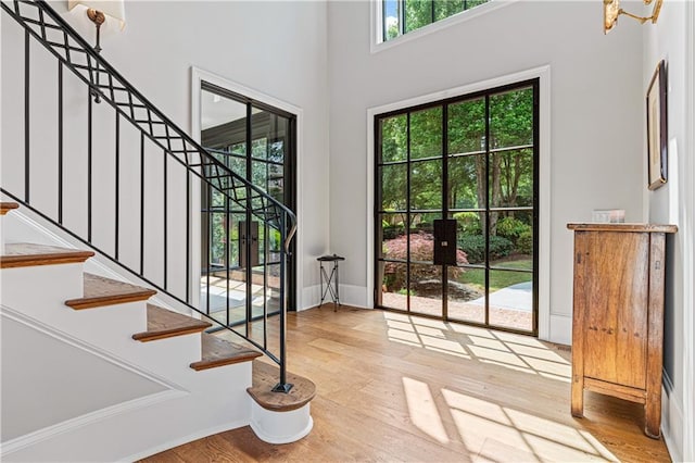 6515 Ashbourne Ct, Suwanee, GA 30024 - foyer entrance featuring stairs, wood finished floors, baseboards, and a high ceiling
