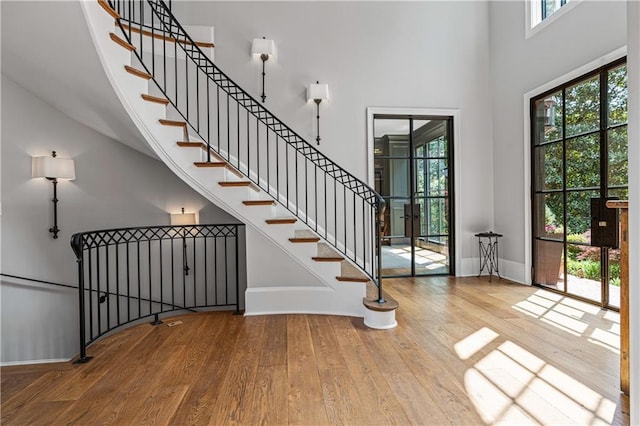 6515 Ashbourne Ct, Suwanee, GA 30024 - foyer with wood finished floors, a high ceiling, baseboards, and stairway