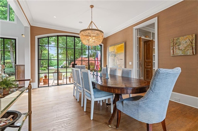 6515 Ashbourne Ct, Suwanee, GA 30024 - dining space with a chandelier, healthy amount of natural light, wood finished floors, crown molding, and baseboards
