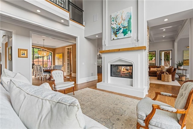 6515 Ashbourne Ct, Suwanee, GA 30024 - living room with crown molding, wood finished floors, a multi sided fireplace, recessed lighting, and baseboards
