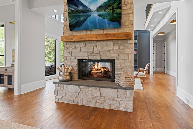 6515 Ashbourne Ct, Suwanee, GA 30024 - detailed view of wood finished floors, baseboards, a fireplace, and recessed lighting