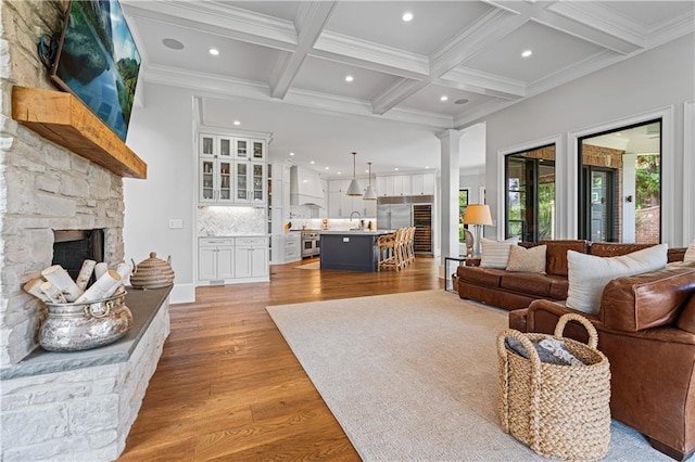 6515 Ashbourne Ct, Suwanee, GA 30024 - living area featuring coffered ceiling, a stone fireplace, light wood-style floors, recessed lighting, and beam ceiling
