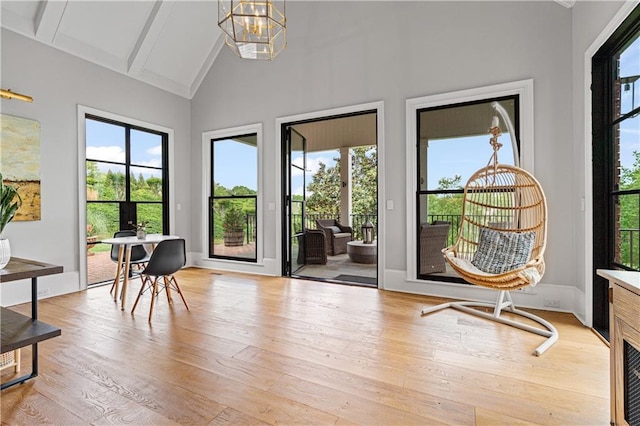 6515 Ashbourne Ct, Suwanee, GA 30024 - sitting room with healthy amount of natural light, light wood finished floors, beamed ceiling, a chandelier, and high vaulted ceiling