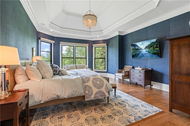 6515 Ashbourne Ct, Suwanee, GA 30024 - bedroom featuring a chandelier, wood finished floors, a raised ceiling, ornamental molding, and baseboards