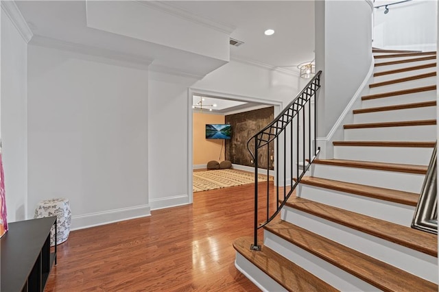 6515 Ashbourne Ct, Suwanee, GA 30024 - stairs featuring crown molding, wood finished floors, baseboards, recessed lighting, and a chandelier