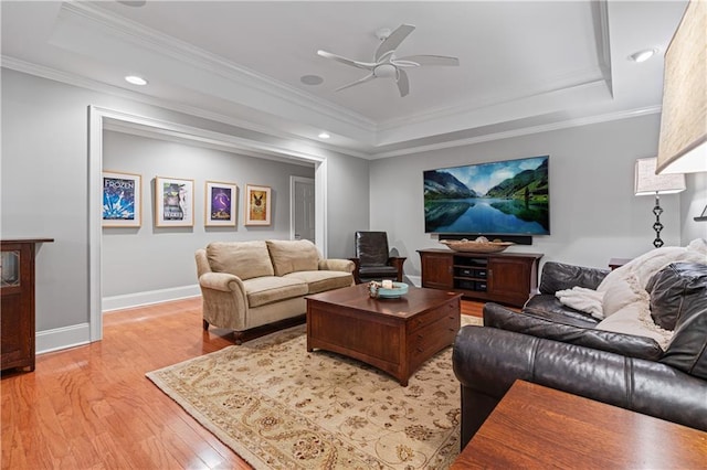 6515 Ashbourne Ct, Suwanee, GA 30024 - living room with a raised ceiling, light wood-style flooring, baseboards, a ceiling fan, and crown molding