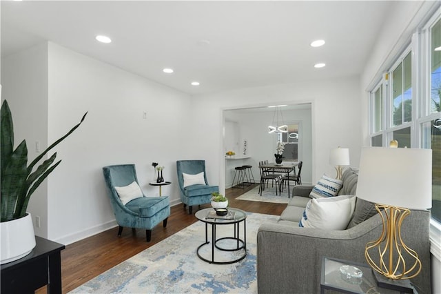 living area with dark wood-style floors, baseboards, and recessed lighting