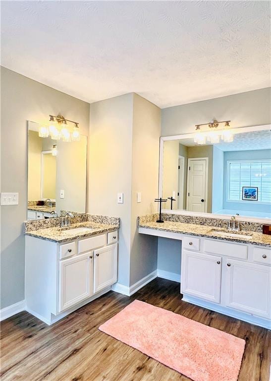 bathroom with vanity, hardwood / wood-style floors, and a textured ceiling