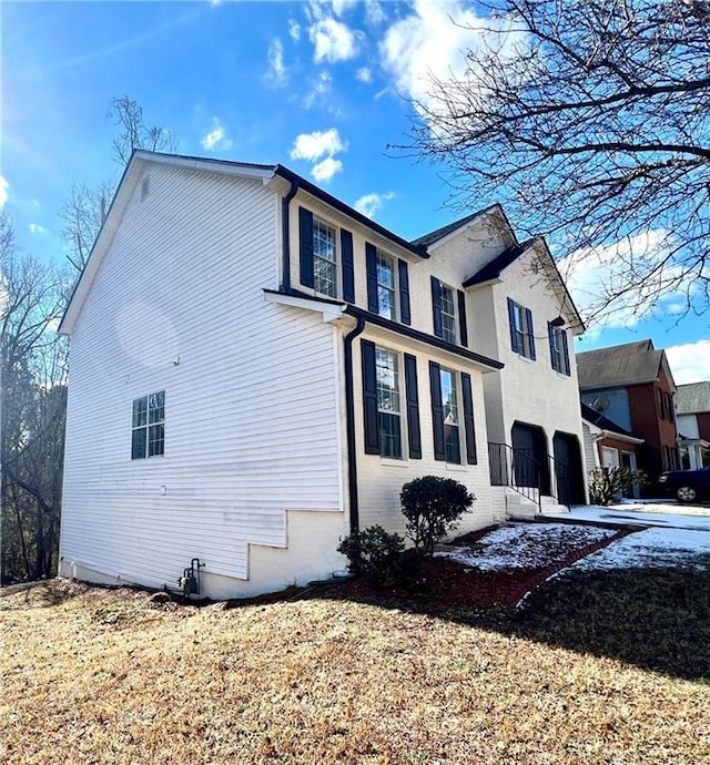 view of side of home with a garage