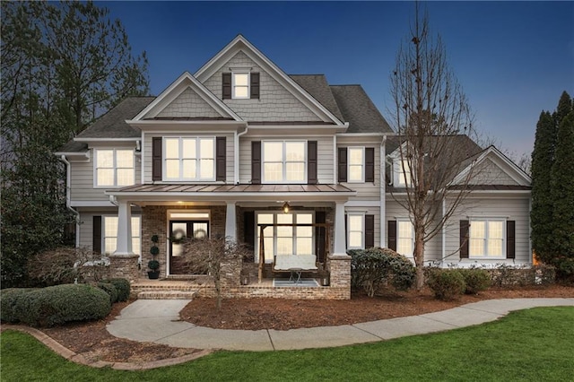 craftsman-style home with a porch and a yard