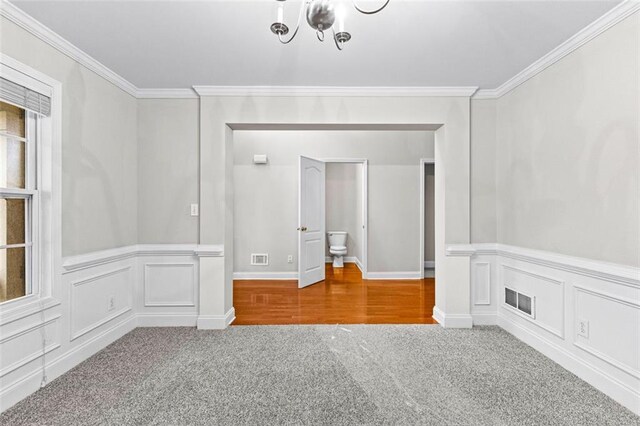 2443 High Meadows Ct, Conyers, GA 30094 - carpeted spare room featuring ornamental molding, visible vents, a decorative wall, and a notable chandelier
